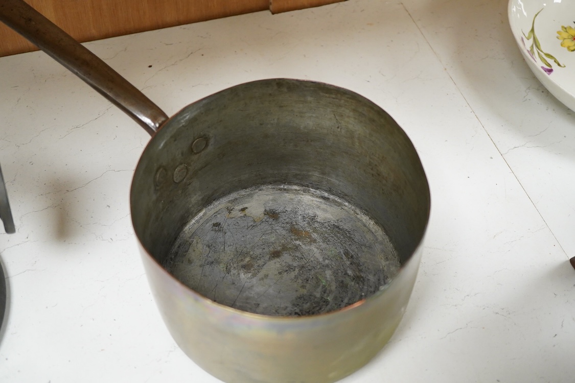 A bronze bell dated 1839 and two Victorian copper and brass saucepans